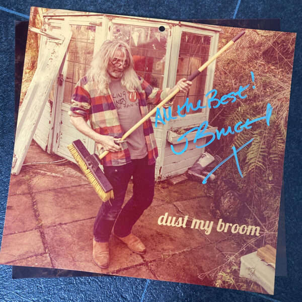 Signed image of John with a broom